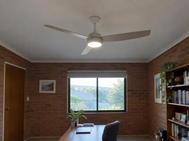 Ceiling fan on a white ceiling above a brick-walled home office with a window and desk in Lake Haven